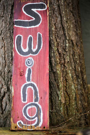 a hand painted sign for the cottage tree swingの写真素材