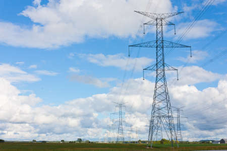 A line of hydro towers reach into the distance, contrasting the rural farmland landscape of Bruce...