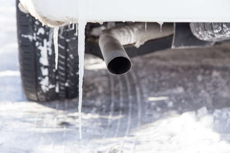 ice forming on the back underside of a car in an icy drivewayの写真素材
