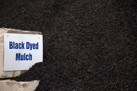 bulk pile of black dyed mulch used for landscaping projectsの写真素材