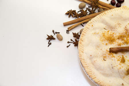 Overhead partial view of a fresh baked apple pie with whole spices, leaving lots of room for copy