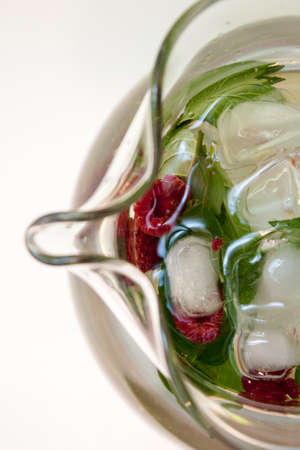 overhead view of ice water infused with raspberries and fresh mint leavesin a glass pichterの写真素材