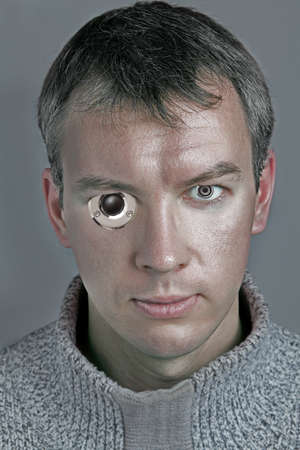 a man with audio speakers instead of his eyesの写真素材