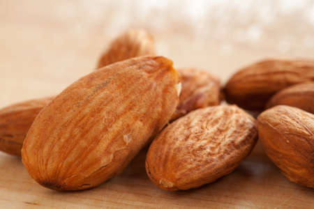 Almonds on wooden background の写真素材