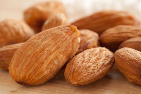 Almonds on wooden background の写真素材