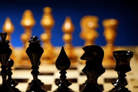 black and white chess against each other on chess boardの写真素材