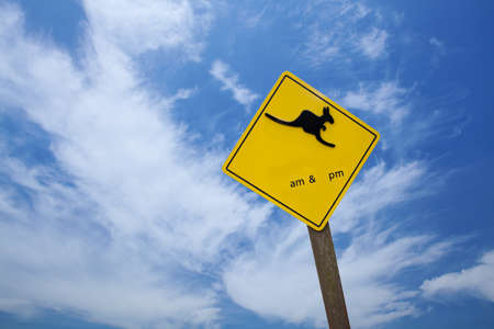 Kangaroo traffic warning sign against blue skyの写真素材