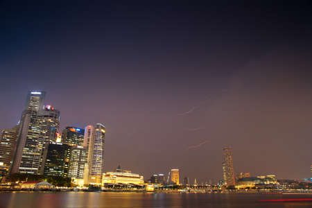 SINGAPORE- APRIL 23: Storm over the Singapore Downtown Core on April 23, 2012 in Singapore. The area which is now known as the Downtown Core is the financial, administrative and commercial centre.のeditorial素材