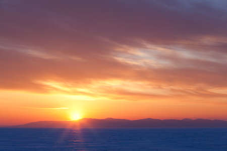 Winter sunset over seaの写真素材