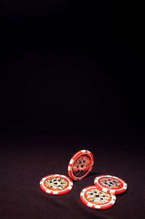 Heap of red poker chips on black backgroundの写真素材