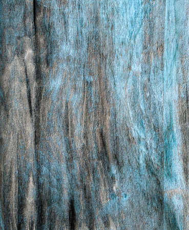 Rustic hardboard texture with strokes, scratches, cracks and  blue peeled paint. の写真素材