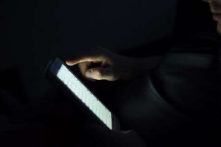 Image of using touch pad. Screen and male hand. Low key. Internet communication concept.