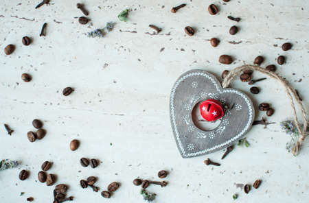 Wooden Christmas toy on the table. Heart, coffee beans and spices. Flat lay, top view. Rustic Christmas background.の写真素材