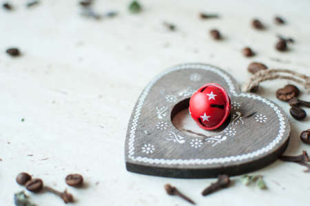 Wooden Christmas toy on the table. Heart, coffee beans and spices close up. Rustic Christmas...