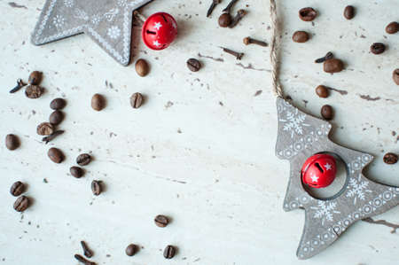 Wooden Christmas toys on the table. Tree, star, coffee beans and spices. Flat lay, top view. Rustic Christmas background.の写真素材