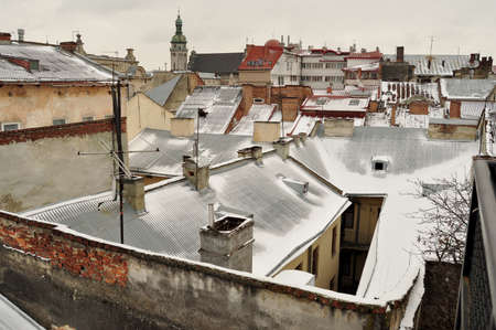 Old buildings and snow-covered roofs. Winter view of the downtown in Lviv, Ukraine.の写真素材