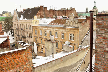 Old buildings and snow-covered roofs. Winter view of the downtown in Lviv, Ukraine.の写真素材