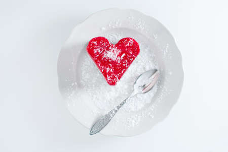 Pastry heart with jelly on white plateの写真素材