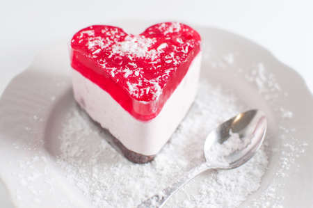 Pastry heart with jelly on white plateの写真素材