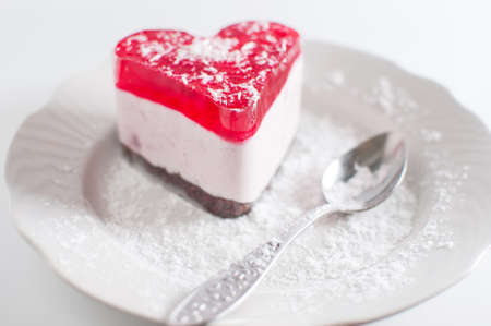 Pastry heart with jelly on white plateの写真素材