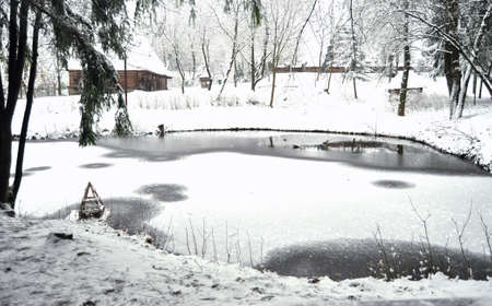 Wooden bridge on a frozen lake in a winter forest. Scenic winter landscape.の写真素材