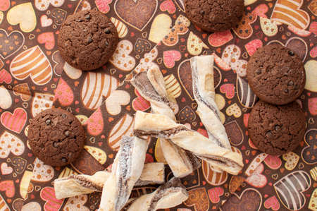 Cookies on dark napkin with image of heartsの写真素材