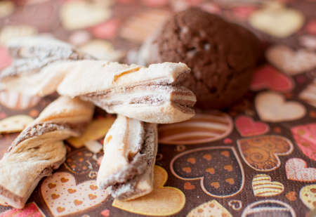 Cookies on dark napkin with image of hearts close up. Selective focus.の写真素材
