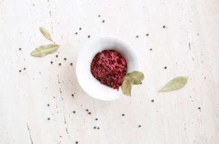Homemade fresh tomato sauce with bay leaf in the white bowl. Top view.の写真素材