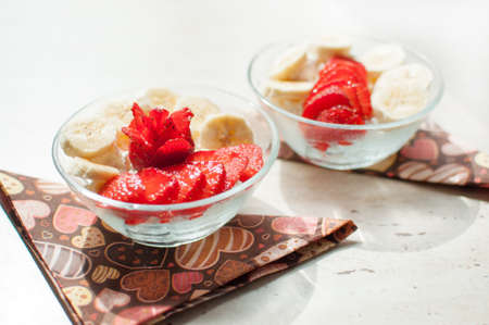 Two bowls of cottage cheese with strawberry and banana. Close-up, selective focus.の写真素材