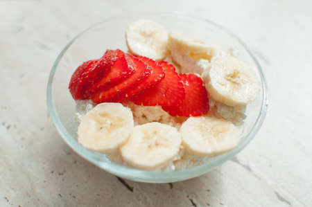 Bowl of cottage cheese with strawberry and banana. Close-up, selective focus.の写真素材