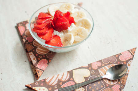 Bowl of cottage cheese with strawberry and banana. Close-up, selective focus.の写真素材