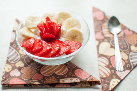 Bowl of cottage cheese with strawberry and banana. Close-up, selective focus.の写真素材