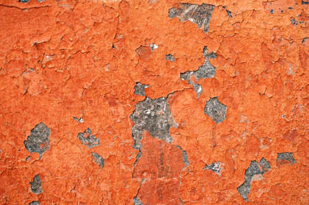 Texture of wall painted with red lead. Uneven spots on a flaked wall.の写真素材