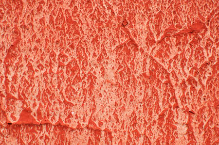 Texture of wall painted with red lead. Uneven spots on a flaked wall.の写真素材