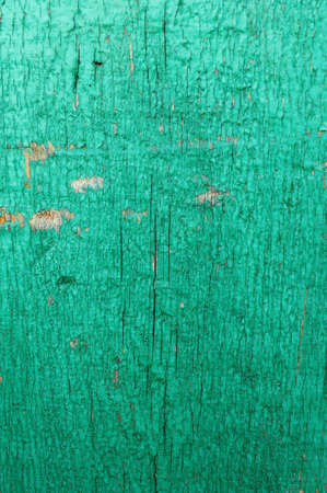 Cracked weathered emerald green shabby chic painted wooden board texture, front view, soft focusの写真素材
