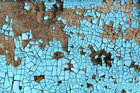 Rustic hardboard texture with scratches, cracks and blue peeling paint. Grunge texture or backgroundの写真素材