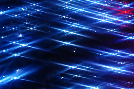 Abstract Christmas blue background. Abstract image of holiday illumination with glowing lights,...