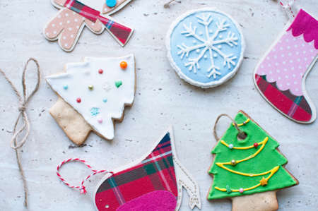 Diversity of Christmas toys - the flat wooden and textile toys and the gingerbread cookies in the different shapes. Top view, flat lay.の写真素材