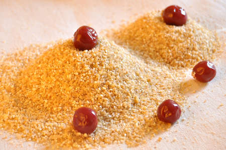 Two piles of wheat grain with canned cherries on the background of sackcloth close-up. Ingredients for cooking.の写真素材