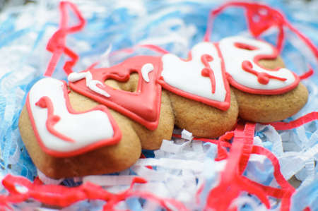 Letter cookies for Valentines day or for a wedding day on the blue and white paper filler background.の写真素材
