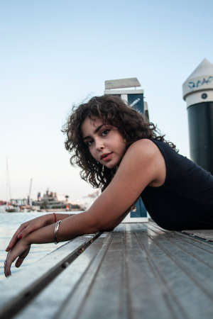 Brunette girl looking and posing.の写真素材