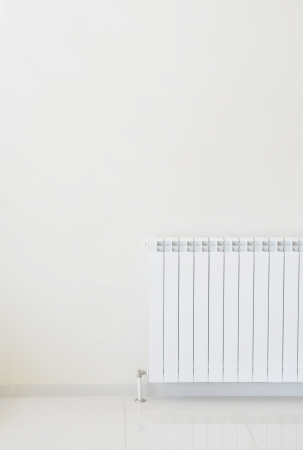 Detail of white wall with a heaterの写真素材