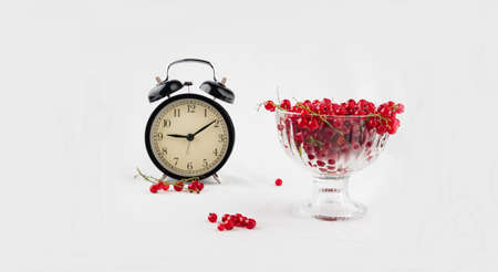 Healthy eating time concept with black alarm clock