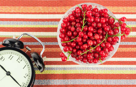 Healthy eating time concept with black alarm clockの写真素材