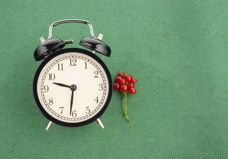 Healthy eating time concept with black alarm clock