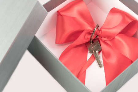 Real estate concept gift in a present box with a red ribbonの写真素材