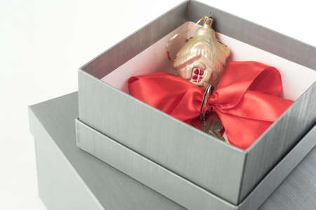 Real estate concept gift in a present box with a red ribbonの写真素材