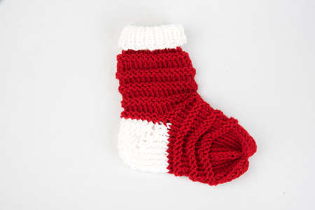 Red and white hand knitted xmas sockの写真素材