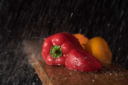 Mini bell peppers under water jetsの写真素材
