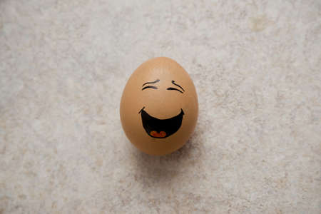 Close-up of Happiness represented by one egg paintedの写真素材